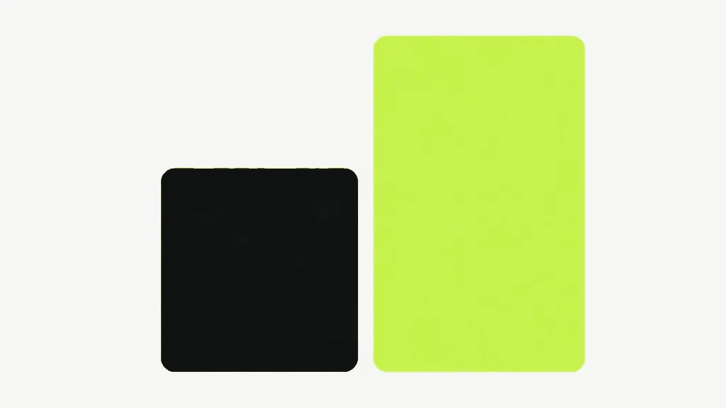 Two plain rounded blocks standing side by side on a pale cool grey background, a squarish near-black one on the left and a taller bright lime one on the right